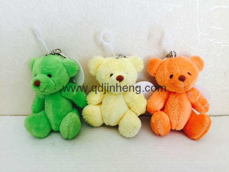 sitting plush bear in green/yellow/orange